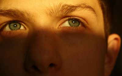 Close-up of a human eye with soft light reflections.